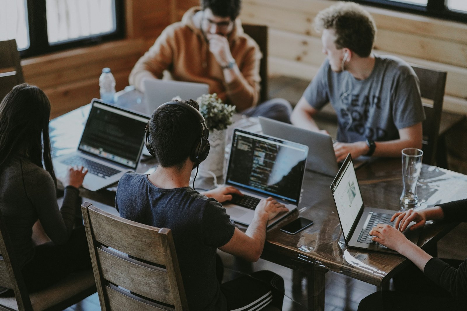 People collaborating around laptops in an office