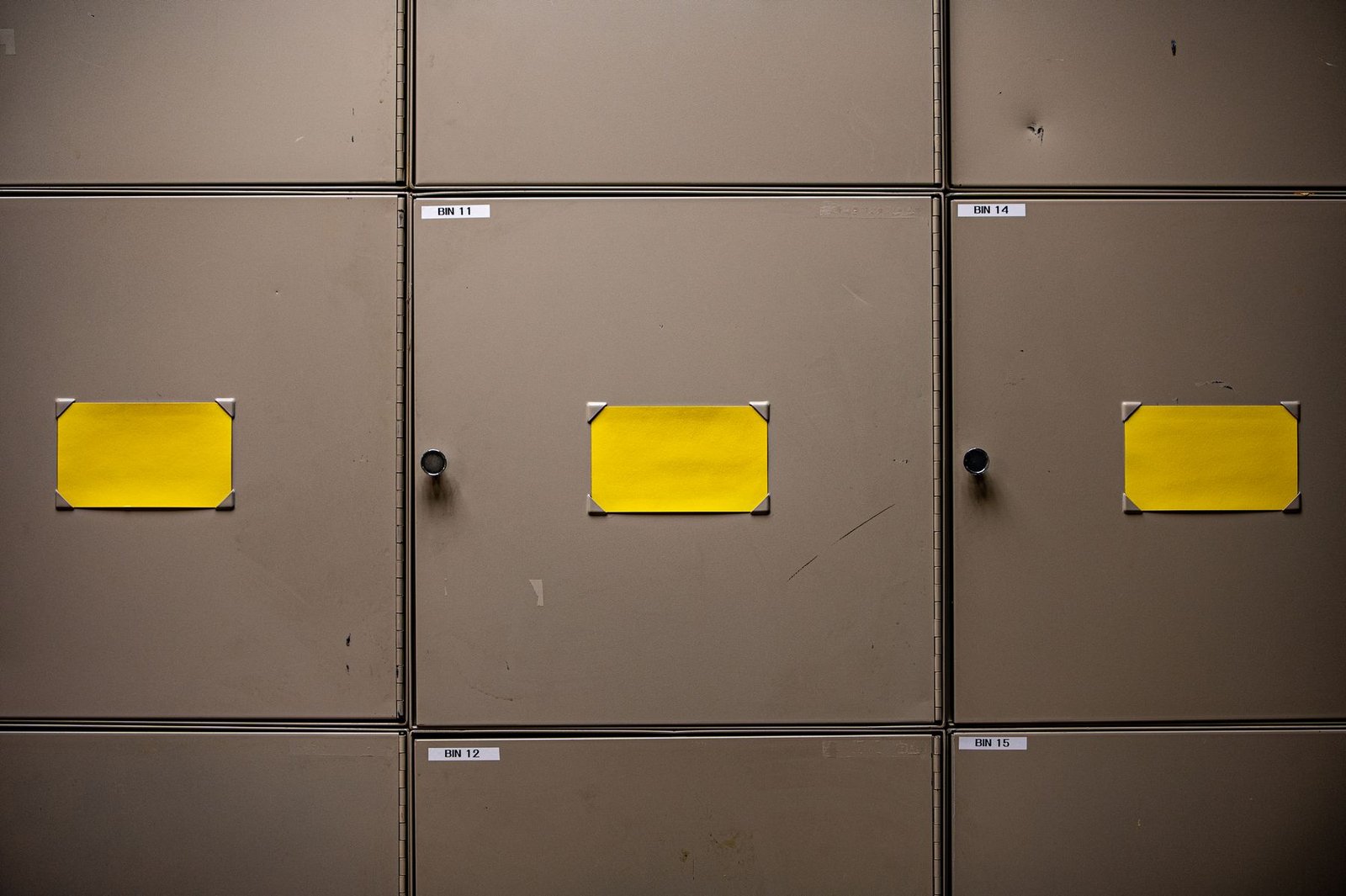 Metal storage cabinets with yellow label holders and small bin labels